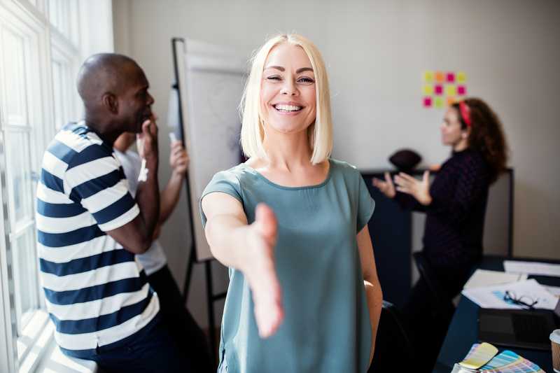 Welcoming woman with hand help out