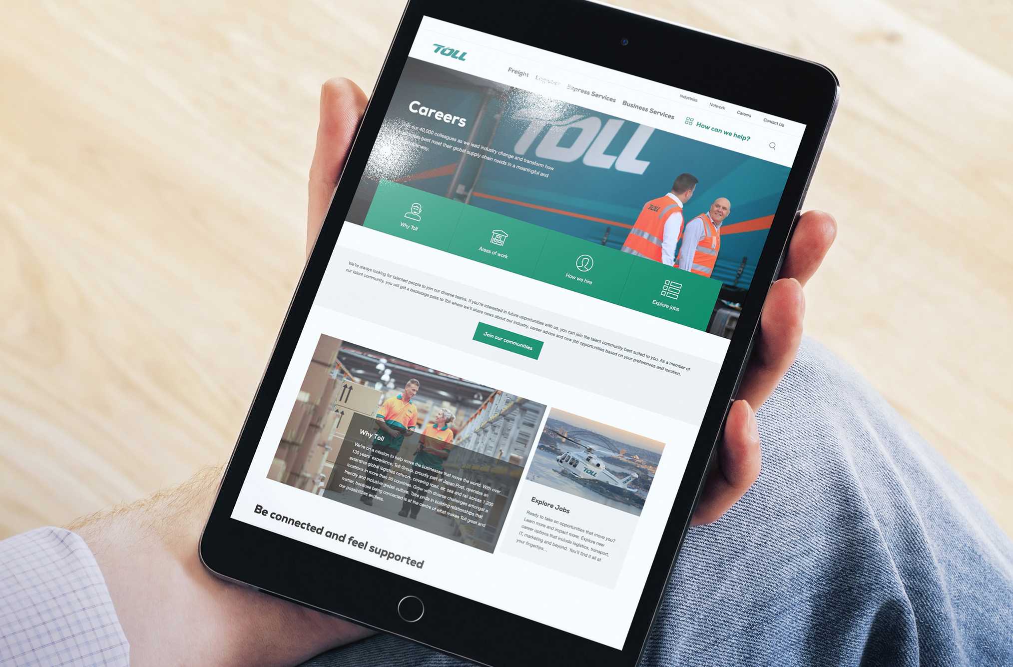 Hand holding a tablet displaying Toll Group's career website | Belong Creative
