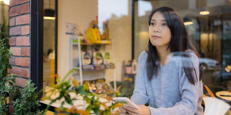 Woman staring into space from cafe