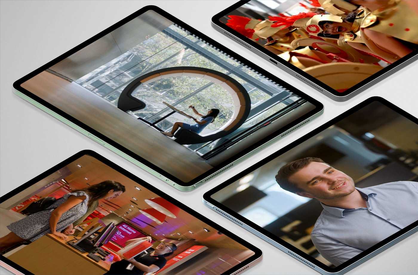 Various videos on tablets showing Employer Brand workplaces