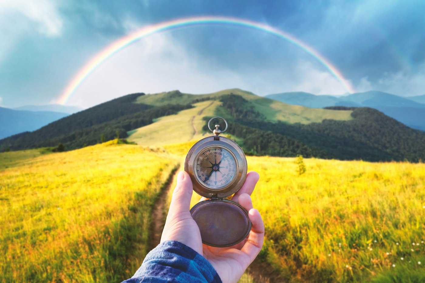 Compass in hand with scenic backdrop symbolizing strategic direction | Belong Creative