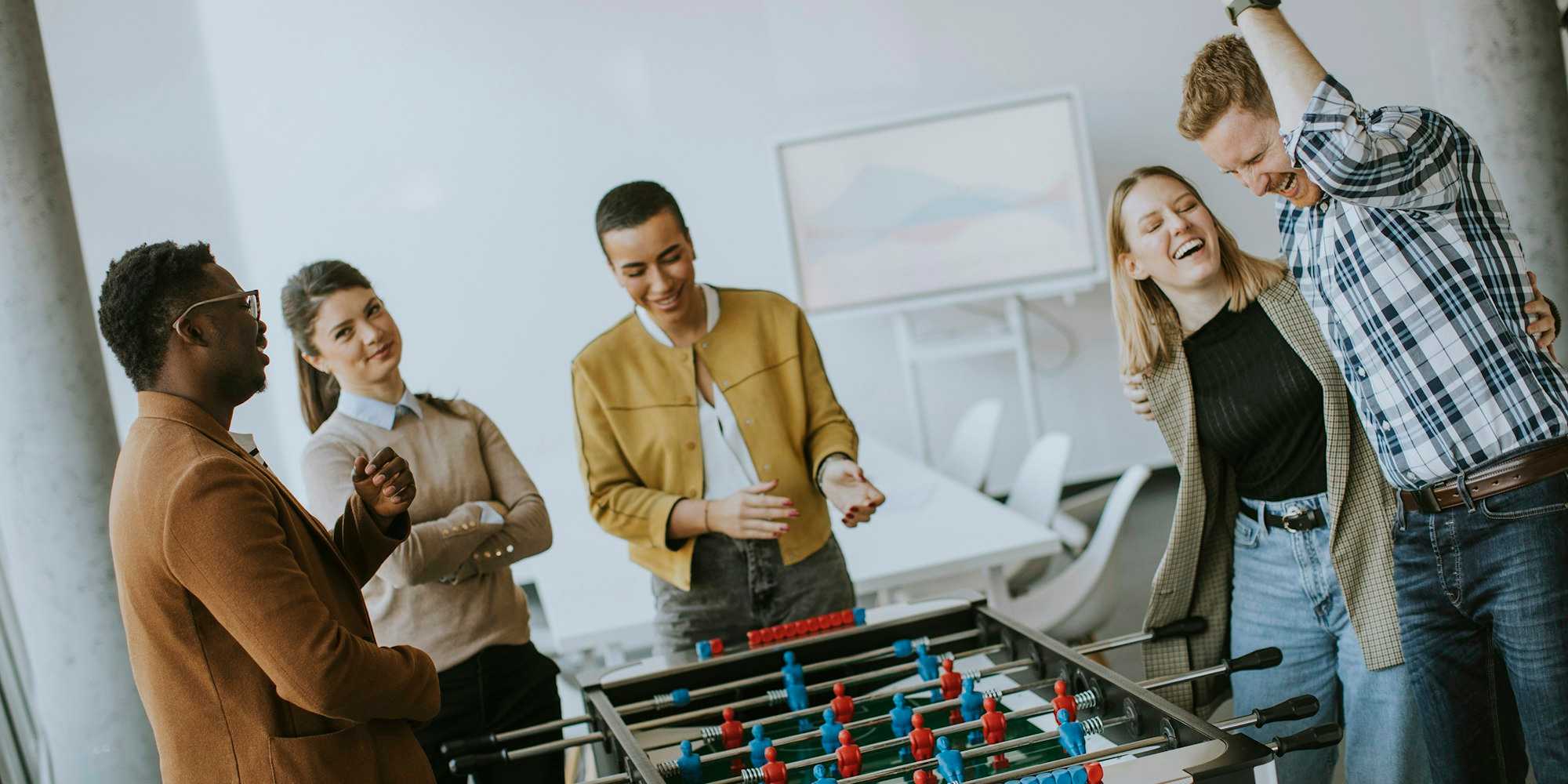 Culture at work - women and man playing fusball