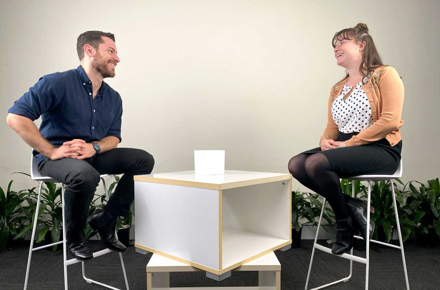 Casual interview setup with two people seated | Belong Creative