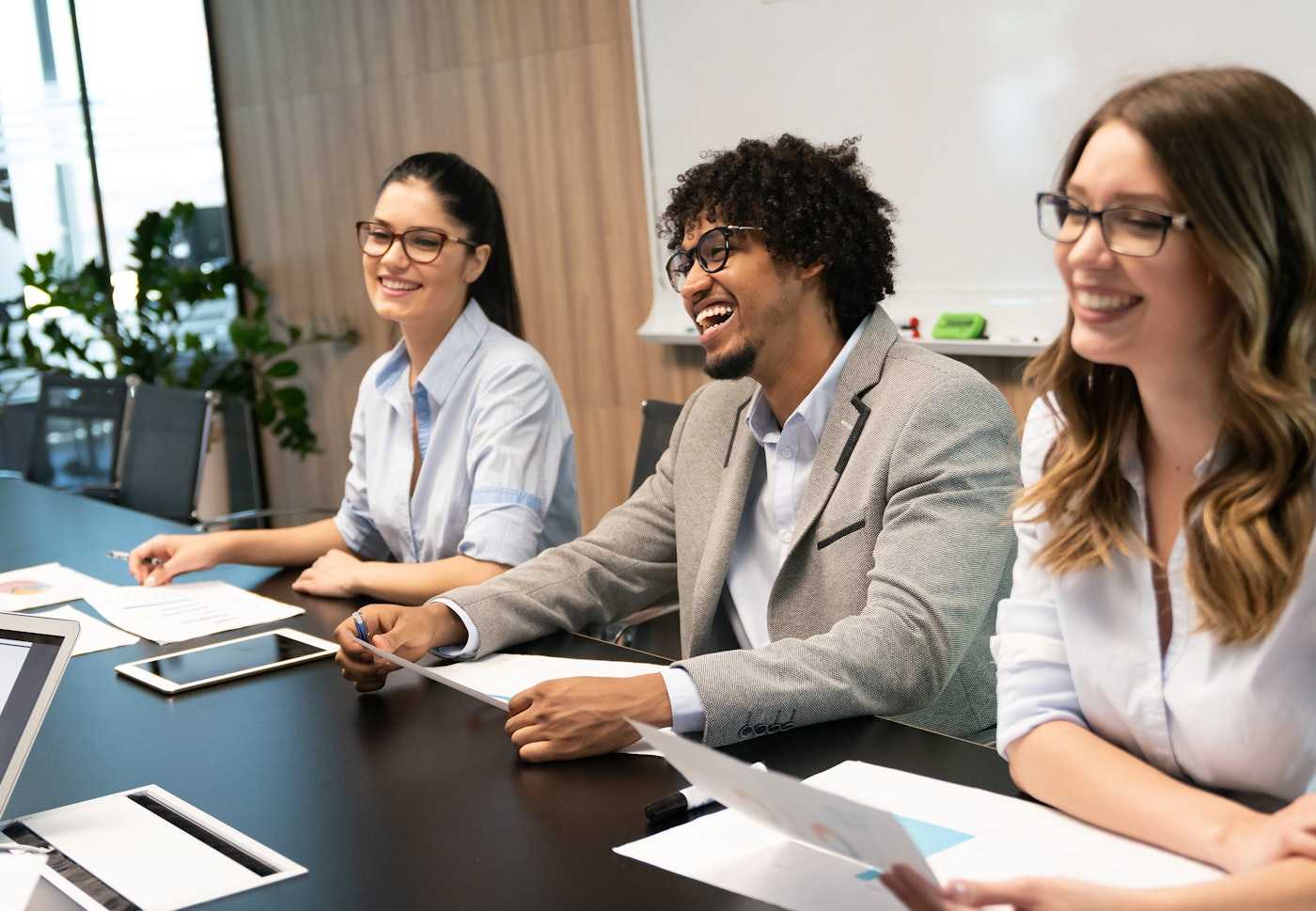 Internal Employee Engagement team of three colleagues in a boardroom