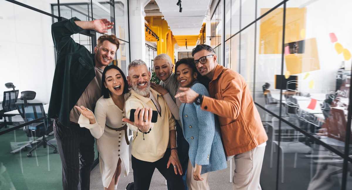 Leader and team at work taking selfie