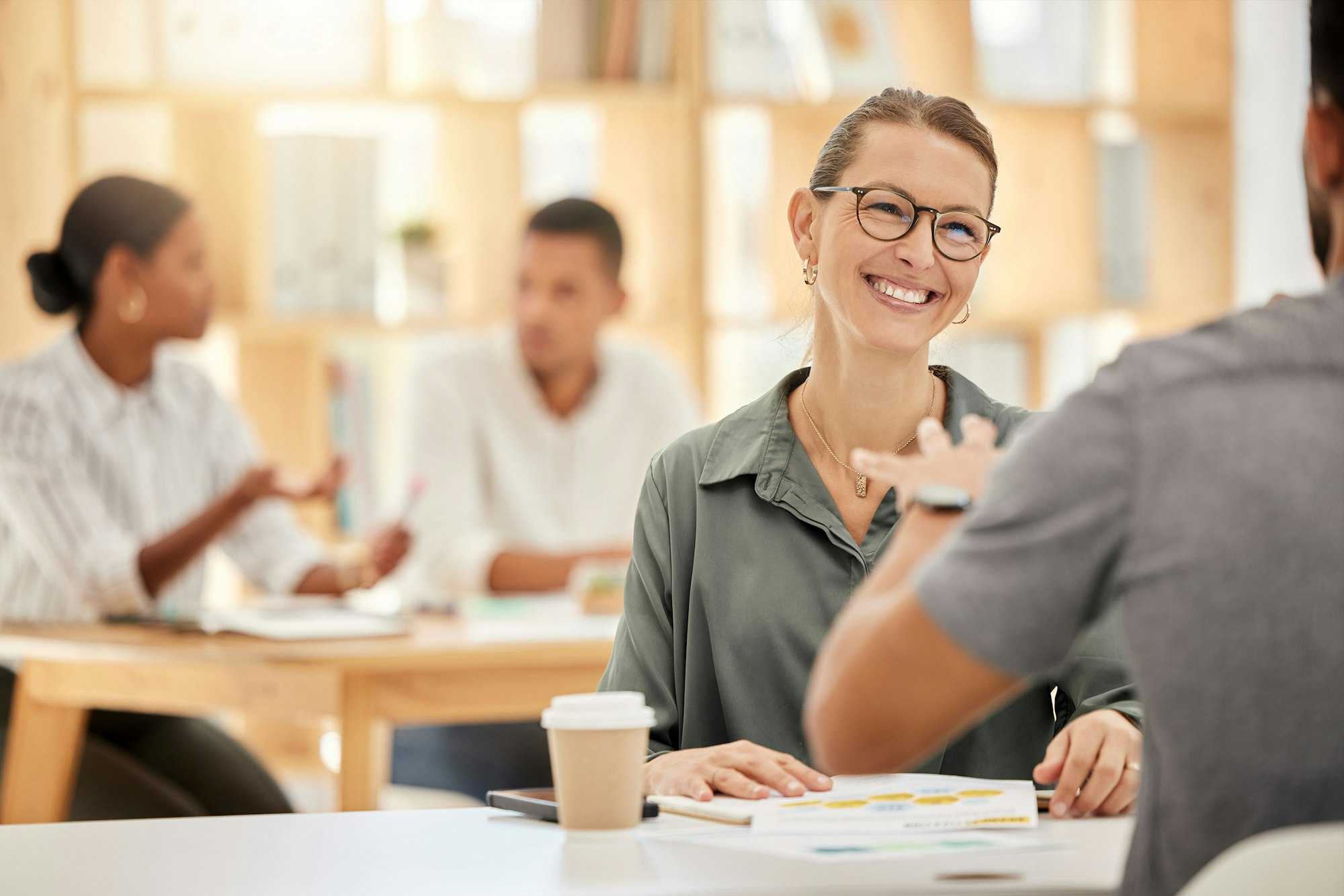 Kind female leader collaborating in cafe