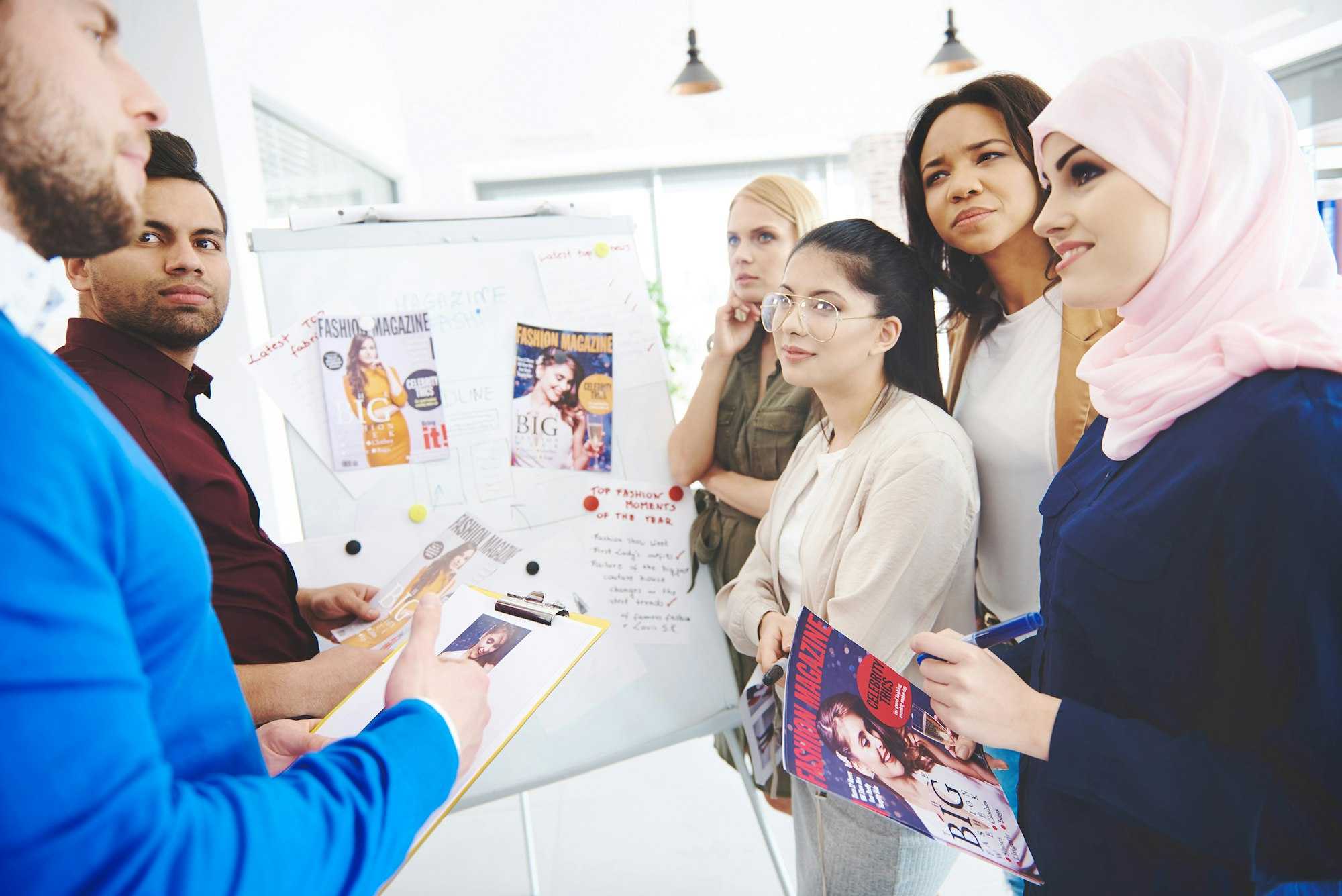 Diverse team reviewing magazine designs