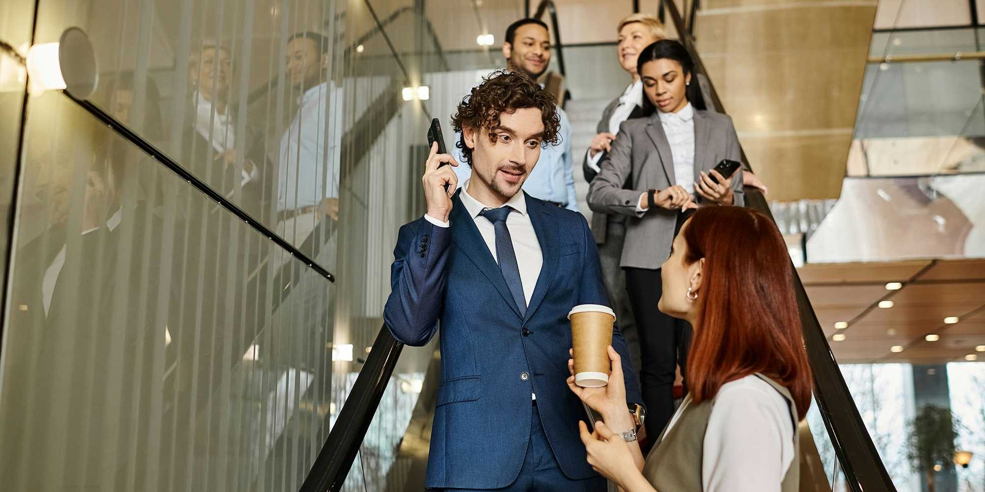 Culture at work - women and man chatting down escalator