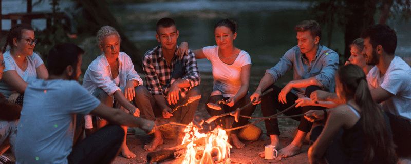 People in front of a camp fire