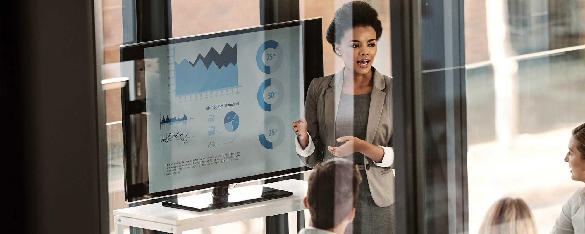 Woman presenting to screen at work