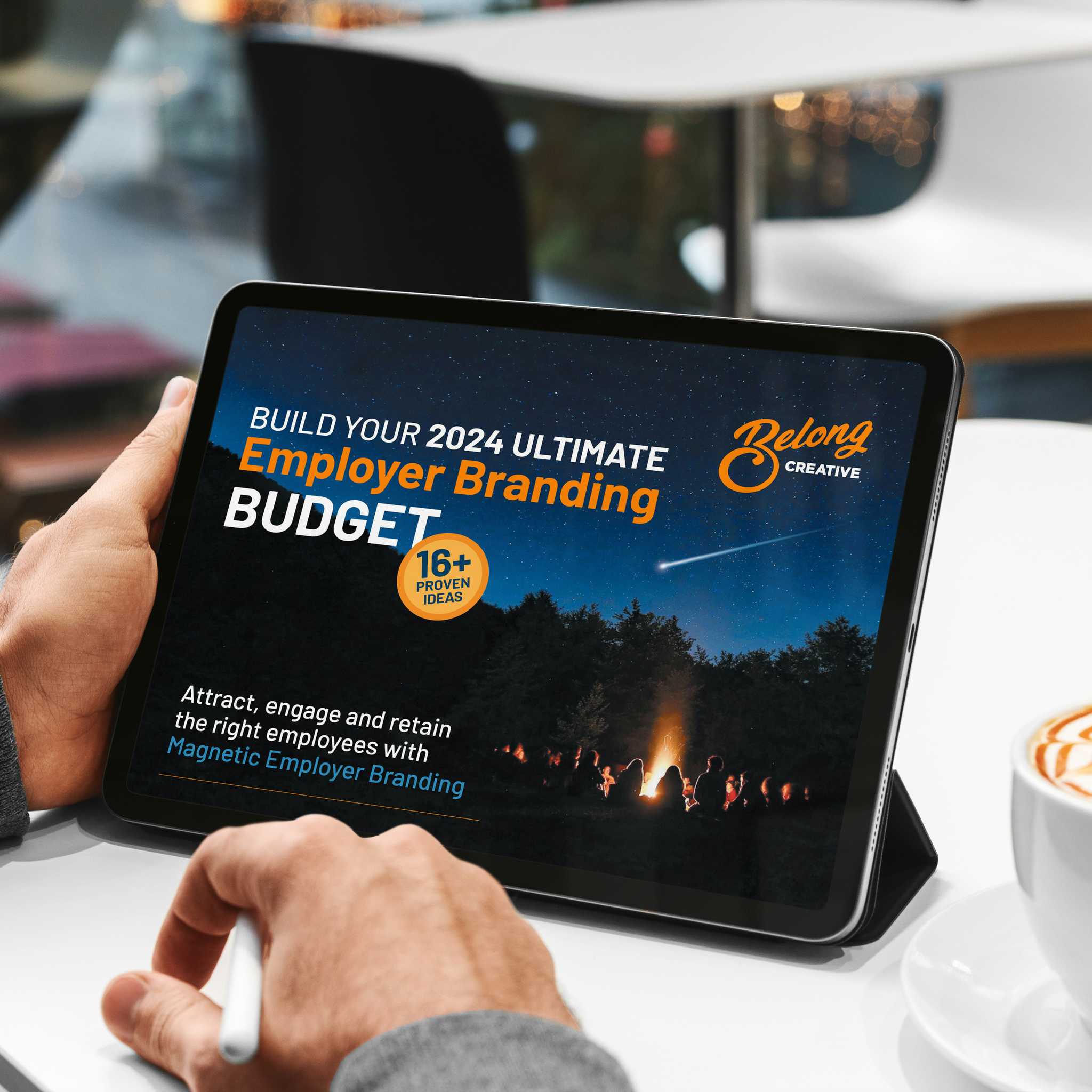 Man at Cafe looking at Employer Brand Budget ebook