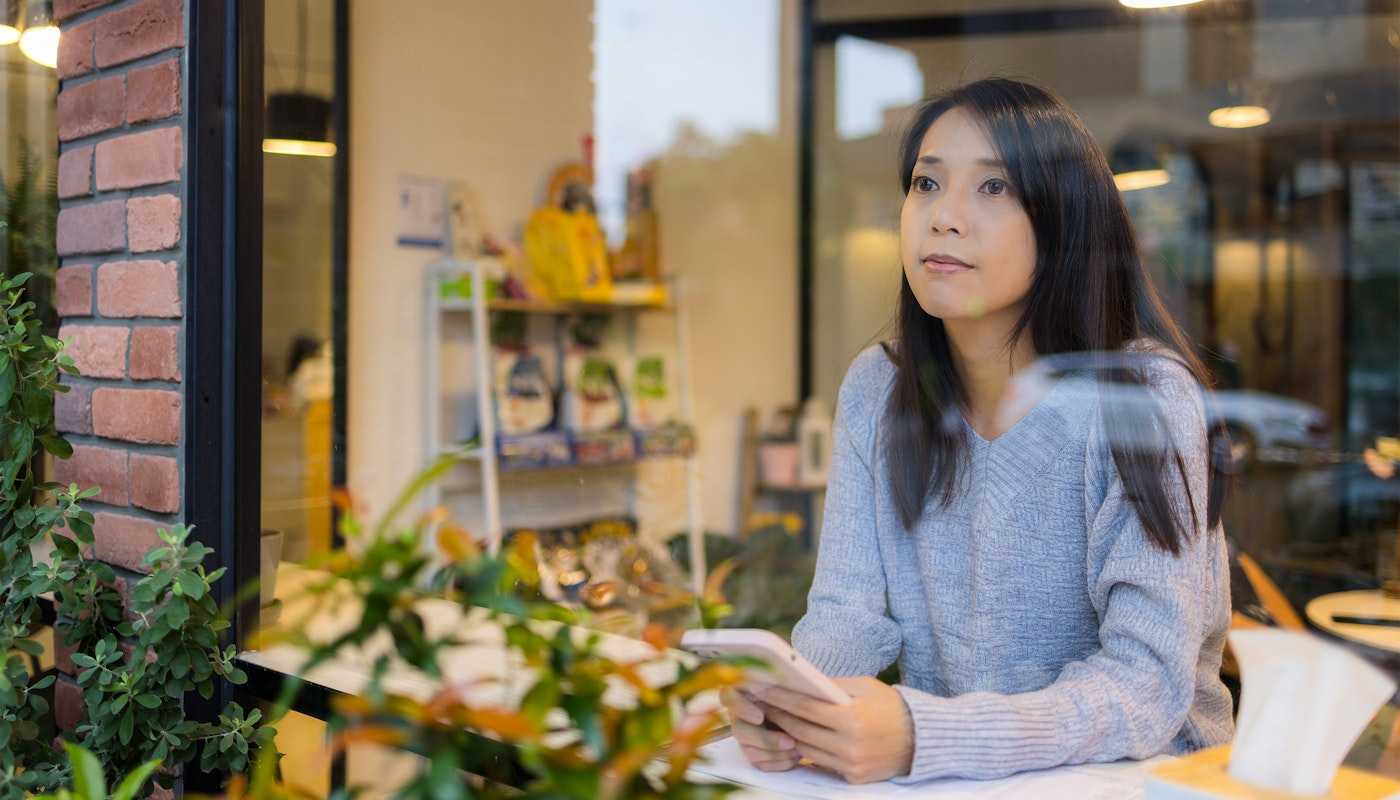 Woman staring into space from cafe