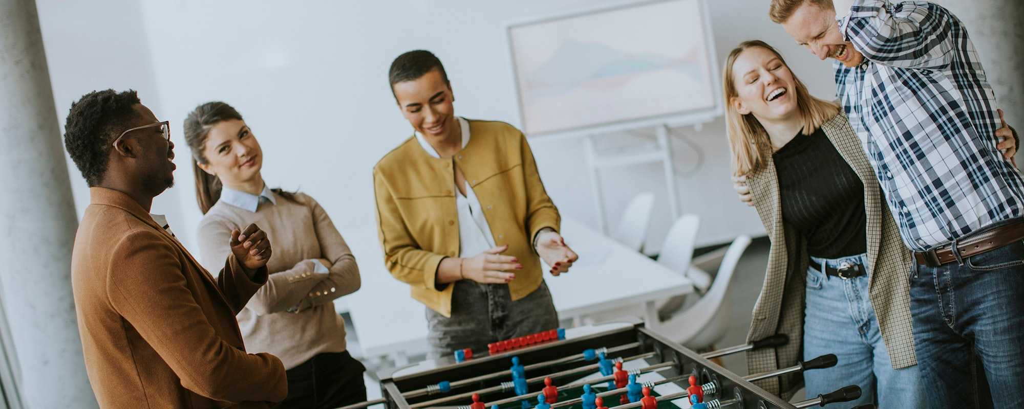 Culture at work - women and man playing fusball