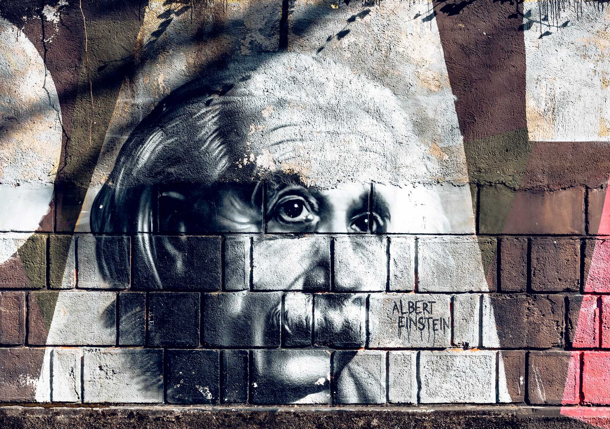 Graffiti of Albert Einstein on a brick wall  