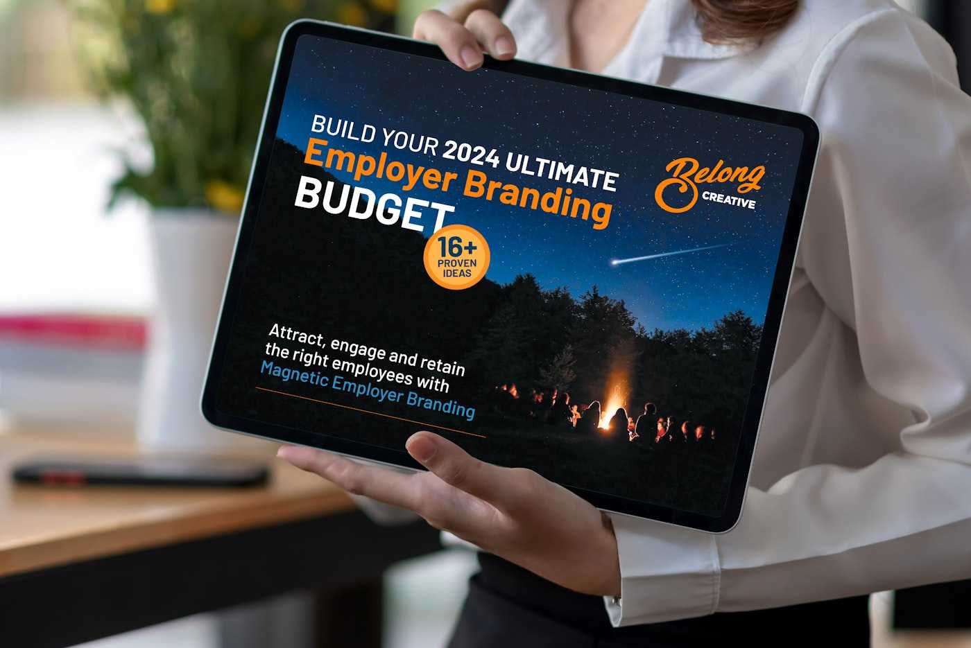 Woman holding ipad with Employer Brand ultimate budget ebook
